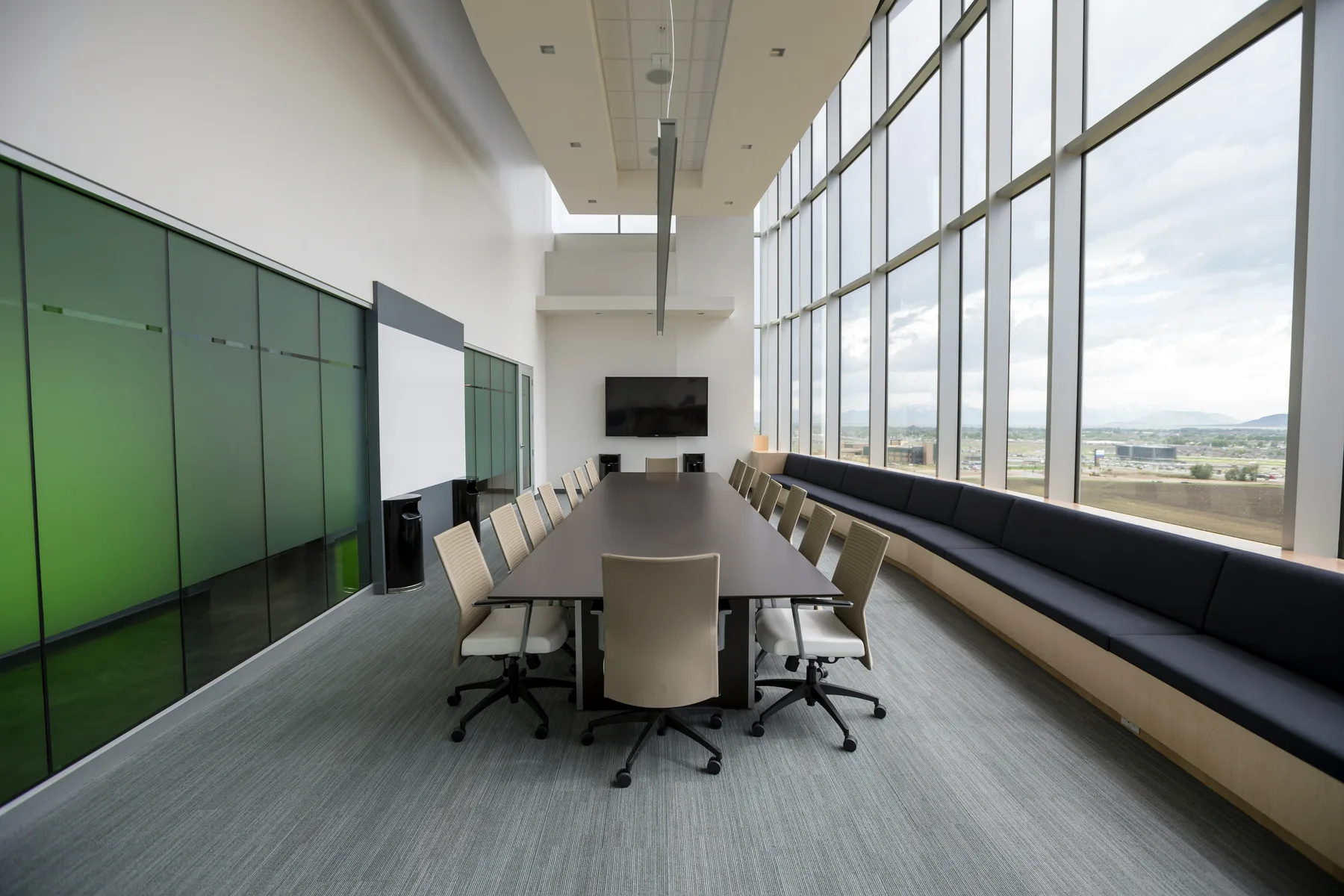 Large modern conference room with a long table and presentation display